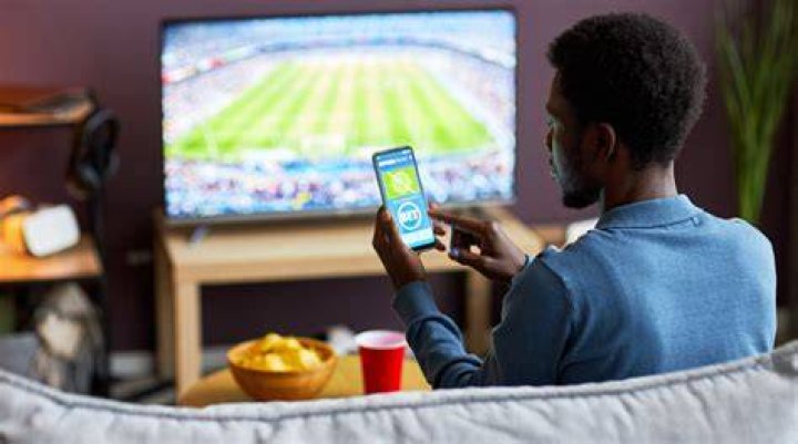 User browsing live cam listings on mobile phone